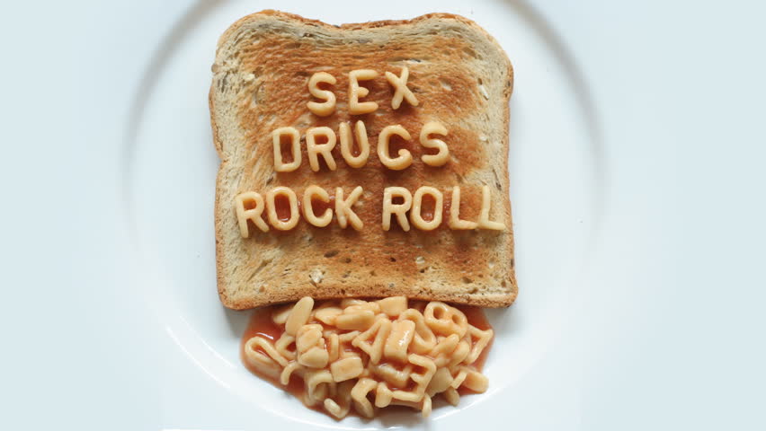 sex drugs rock n roll written with spaghetti pasta letters in tomato sauce on toast