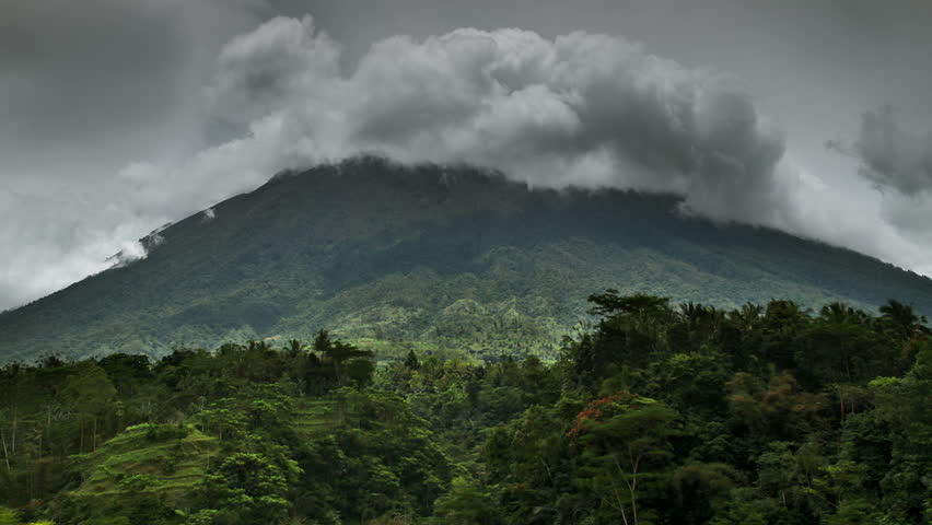 Mount in jungle and time lapse clouds around volcano. 30fps