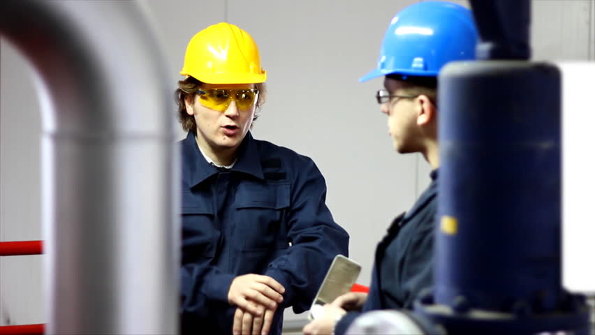 Two workers talking in a factory