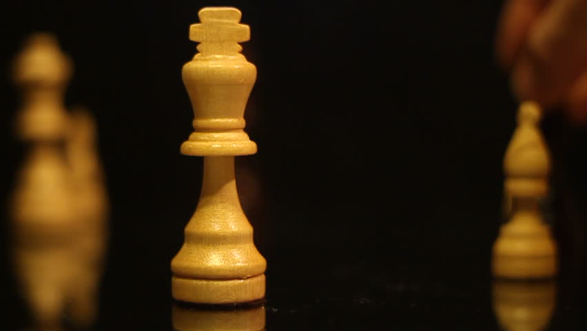 Macro chess checkmate slow motion pieces on a board