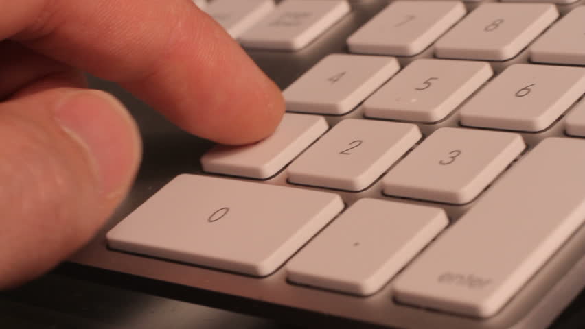 Hands on a computer calculating budget, panning camera