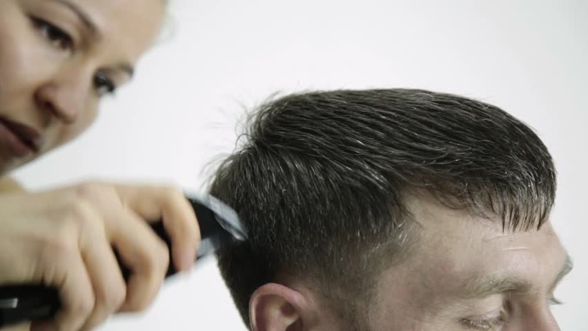 Haircut At Barbershop Hairdresser Uses Scissors For Cutting A Man