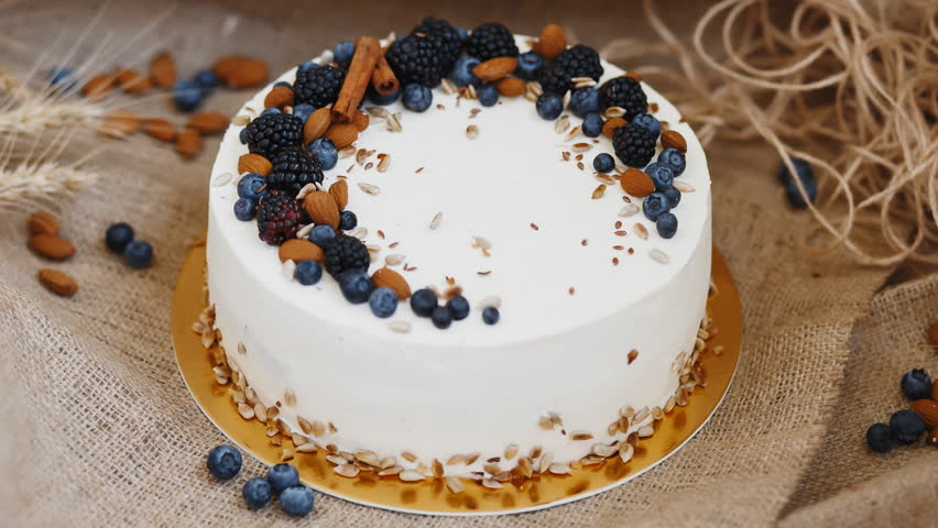 Delicate Cake Decorated With Cinnamon Sticks Nuts Blueberries And