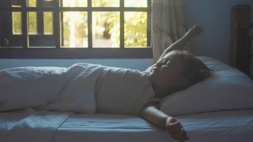 Child Girl Sleeping In Bed At Home And Gradually Waking Up At Morning In Slow Motion Child Girl Sleeping In Bed At Home And Gradually Waking Up At Morning In Slow Motion