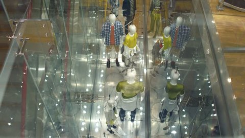 View through window to modern concept manikins at the store. Government manipulation concept.