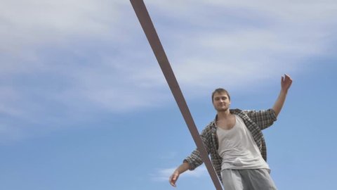 Young man Balancing and jumping On A Slackline At Sea Shore Sand Beach Healthy Body Lifestyle