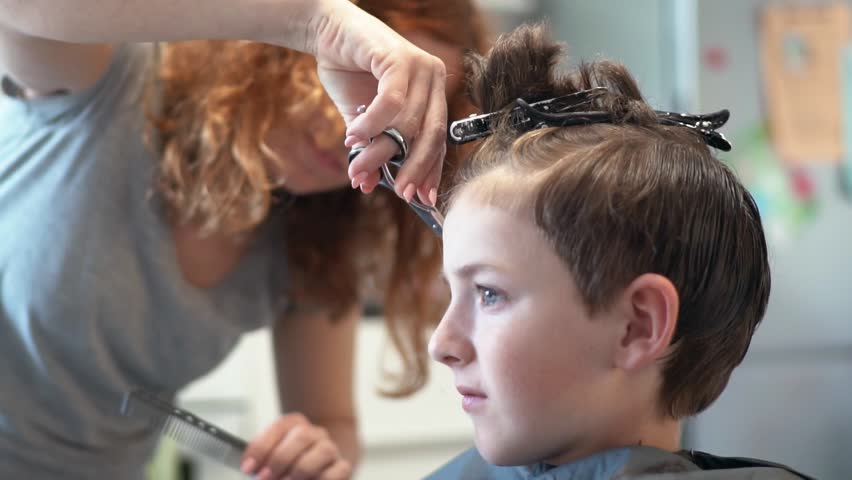 Hd00 20slow Motion A Child In The Swivel Chair For The Hair Stylist