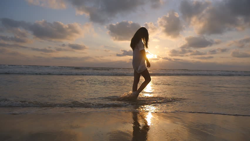 Young woman haveing fun with ocean waves on a tropical beach of image ...