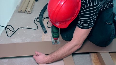 Man Cutting Laminate Flooring With Electric Hand Saw Cutting Laminate Flooring Lengthwise Static Closeup Shot 4k Uhd