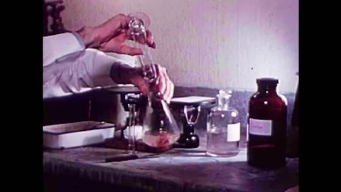 CIRCA 1940s - Pork is artificially digested to test for the parasite Trichinosis in the 1940s
