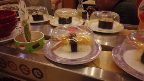 Kuching, Malaysia - April 2019. Variety Of Sushis On Conveyor Belt At Sushi  King Restaurant. Sushi King Is The Largest Japanese Restaurant Chain In  Malaysia