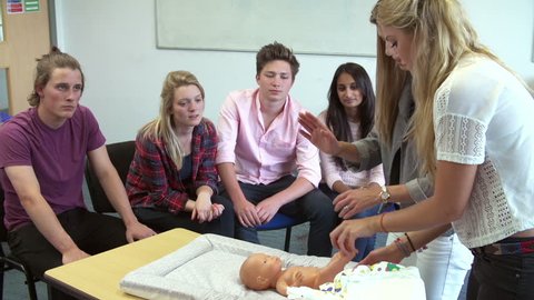 Tutor Instructing College Students In Childcare Class How To Change Nappy Shot On Sony Fs700 Tutor Instructing College Students In Childcare Class How To Change Nappy Shot On Sony Fs700