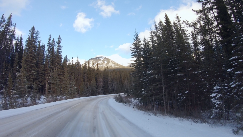 Driving on the road into the mountains in Banff National Park, Alberta ...