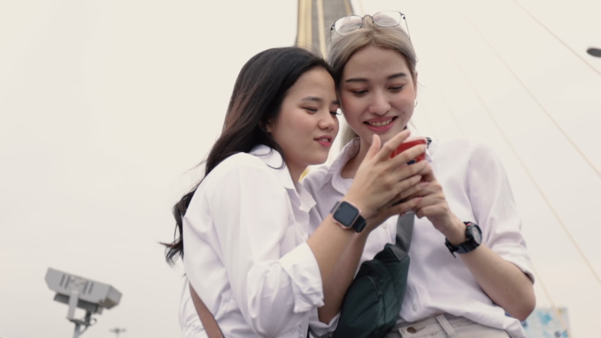Asian Lesbian Couples Using Smartphones Stock Footage