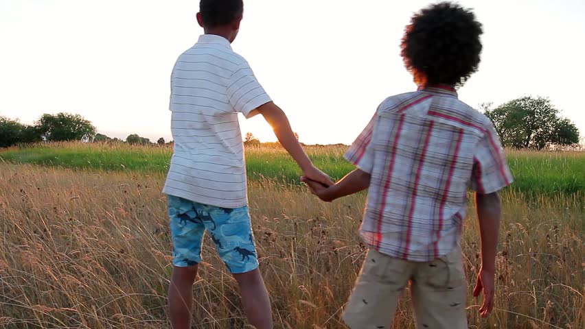 Boy And Long haired Blonde Girl Walking Holding Hands In The Field - 852x480 - jpeg Couple Holding Hands Into The Distance