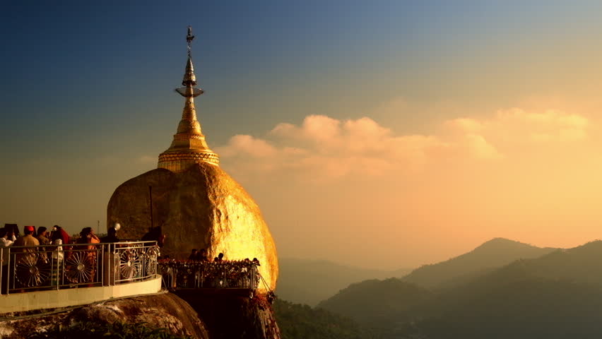 Burmese people praying near Golden Rock | shuttestock