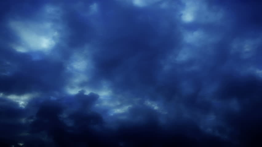 Time Lapse Clouds Billow Through A Dark Blue Sky Loop