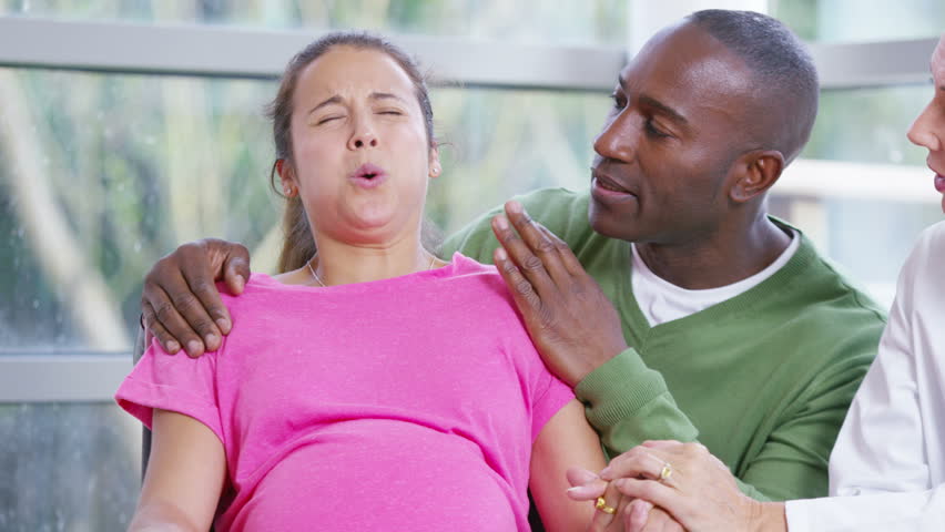 4K Pregnant Woman Going Into Labor Concentrates On Her Breathing Stock