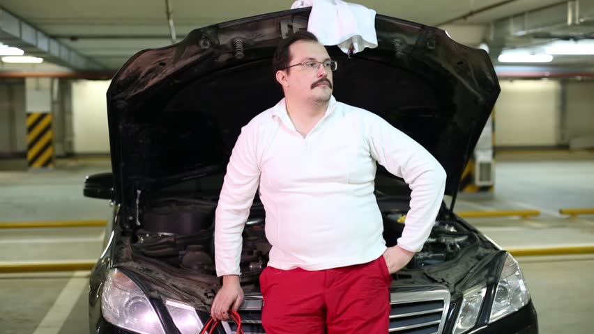 A Man Leans On Stock Footage Video 100 Royalty Free A Man Leans On Car With Wires In His Hands Turned To Connect Them