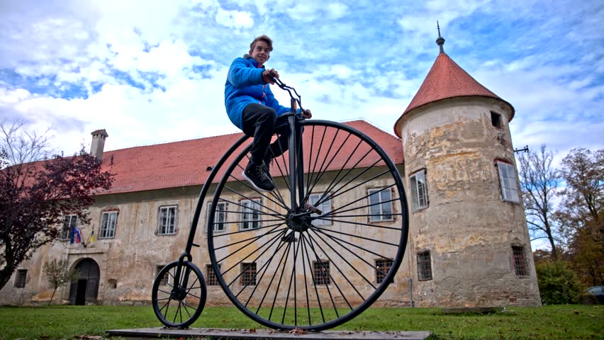 Boy Waving Historical Pennyfarthing 