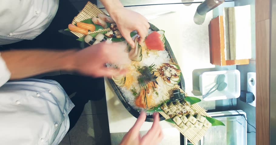 Restaurant Kitchen Hand 4k video shooting: three professional chefs prepare sushi set in a Restaurant Kitchen Hand 4k video shooting: three professional chefs prepare sushi set in a