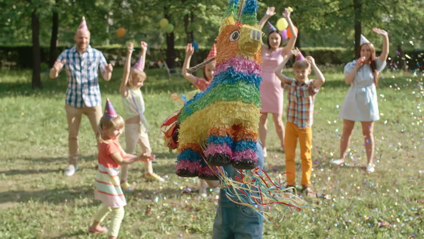 Excited Boy With Blindfold Hitting Pinata With Wooden Bat While Playing ...