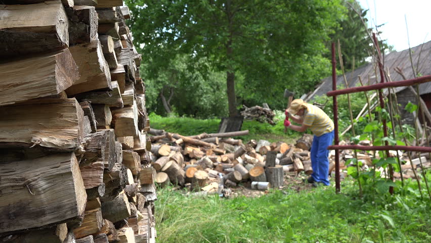 Stock video of stacked firewood and blurred farmer man | 20611630 ...