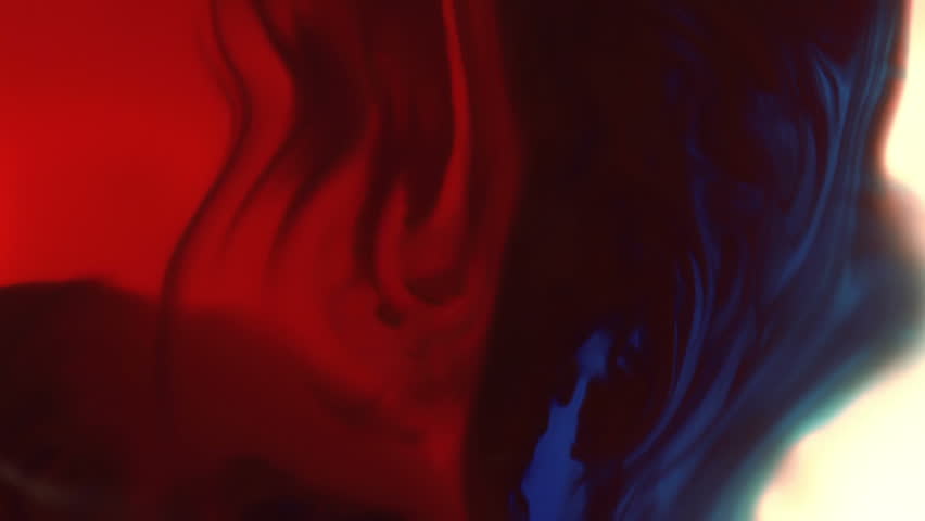 Blue And Red Ink Mixing Together Over A Pure White Background