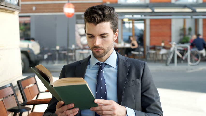 Businessman Answers Cellphone While Reading Stock Footage ...