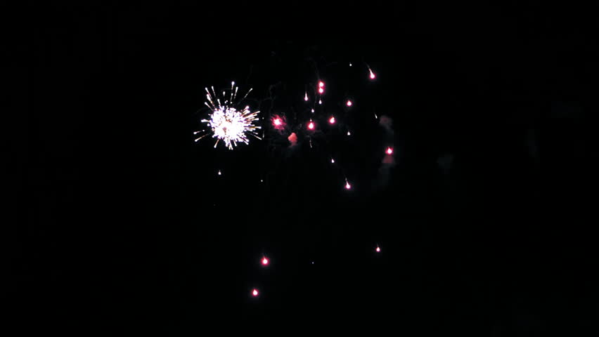 Colorful fireworks in the night sky. Red, blue and green flashes. Clouds of smoke. (av13302c)