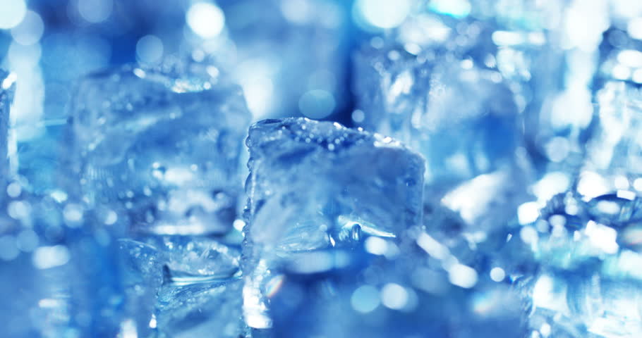 Macro Shot Of Pure Water Ice Cubes That Melt In Slow Motion On A Blue ...