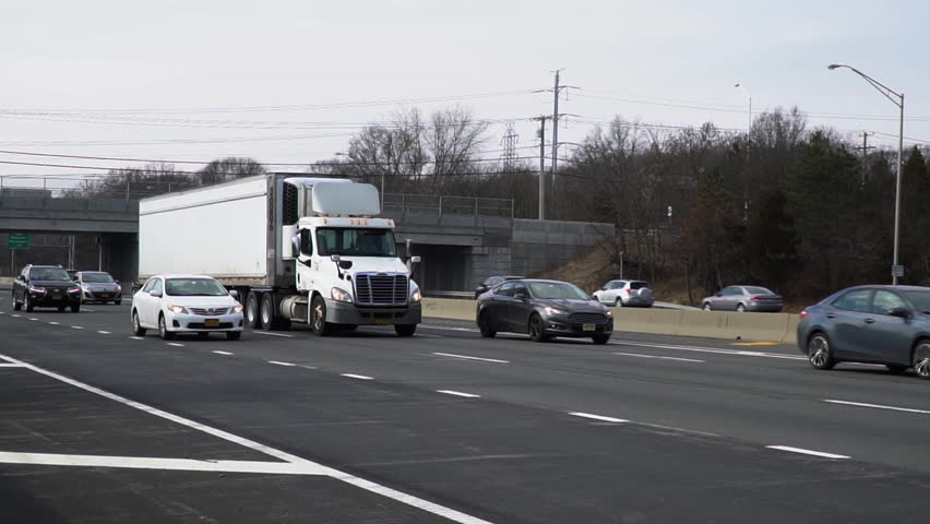 Large Semi Tractor Trailer Stock Footage Video 100 Royalty Large Semi Tractor Trailer Rig Traveling On Long Island Expressway In Slow Motion Towards New York City Cargo Container Vehicle Transport Materials
