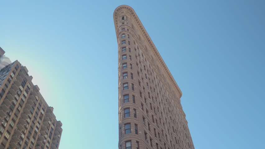 CLOSE UP Famous Flatiron Iron Shaped Building With Limestone And Glazed Terracotta Facade In New York City Parallel To Fifth Avenue Broadway CLOSE UP Famous Flatiron Iron Shaped Building With Limestone And Glazed Terracotta Facade In New York City Parallel To Fifth Avenue Broadway