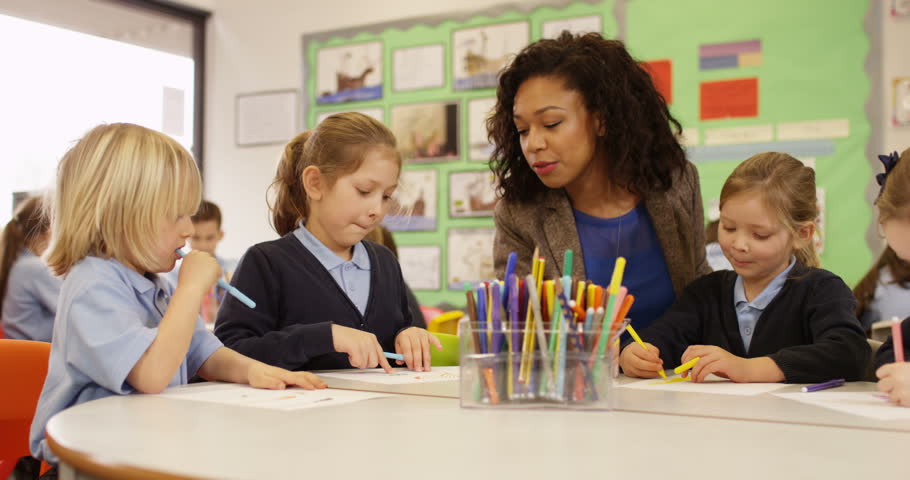 4K Primary School Children Drawing In The Classroom With Teacher ...