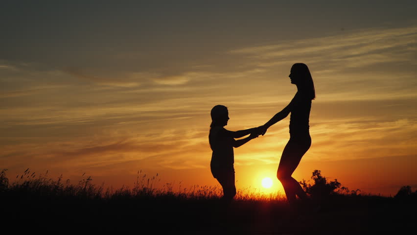 Happy Family: Father, Mother And Baby Playing At Sunset. Silhouettes ...