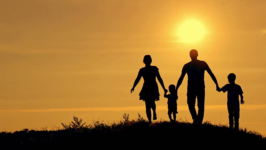 Silhouettes Of Happy Family Running On A Sunset Background Stock ...