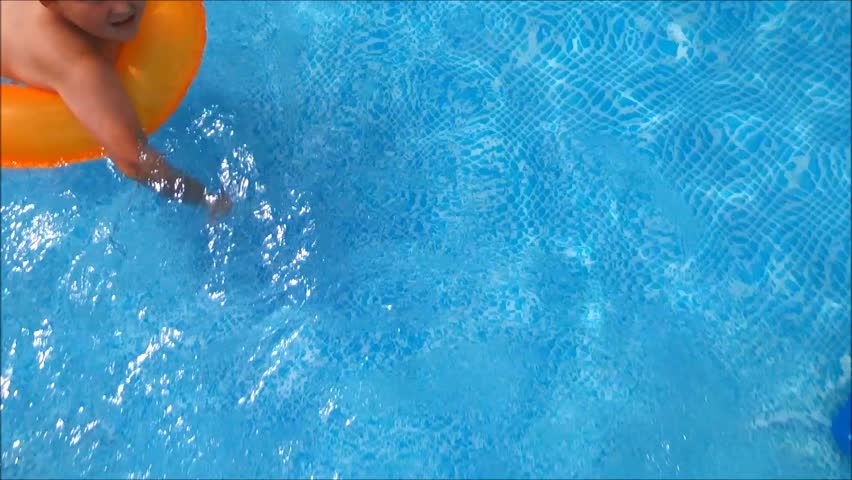 Pool Water Splash a young little girl making water splash with her legs and having Pool Water Splash a young little girl making water splash with her legs and having