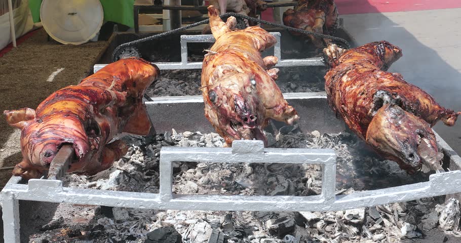 Lambs And Pig Roasting At Rotisserie Fire Pit