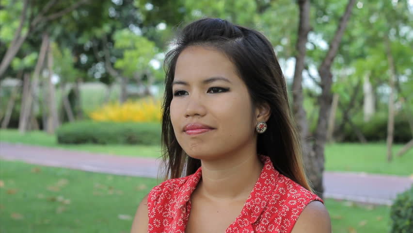 A Beautiful Thai Girl Does A Traditional Thai \u0026quot;wai\u0026quot; Greeting In The Park In Bangkok, Thailand 