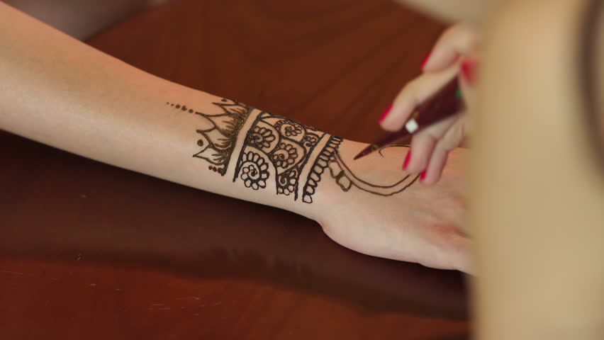 woman making henna tattoo on hand close up mehndi is traditional woman making henna tattoo on hand close up mehndi is traditional