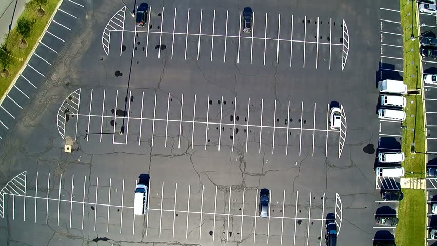 Aerial Shot Of A Slow Landing In A Nearly Empty Parking Lot / Car Park ...