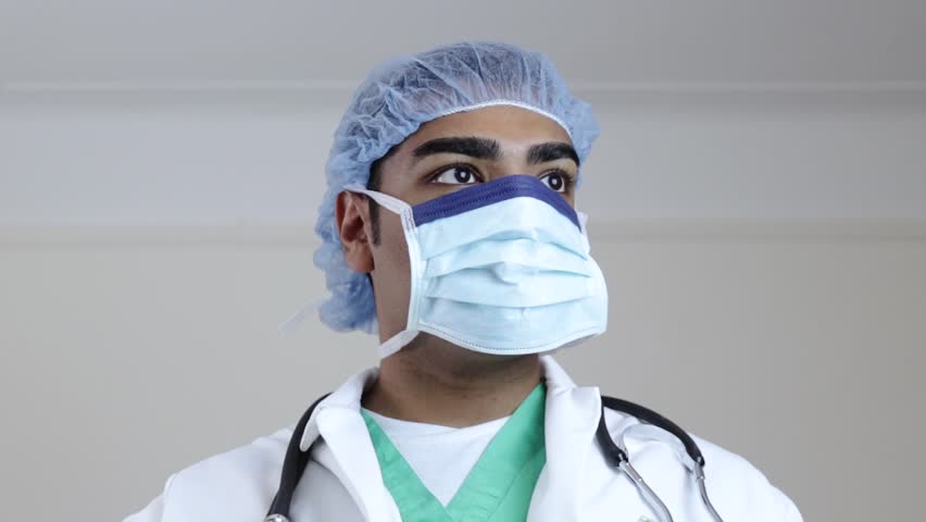 Stock video of surgeon looking to operating room while 