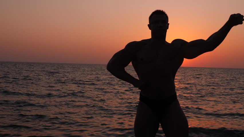 Bodybuilder On Beach Show Muscular Body. Perfect Fit Athlete In ...