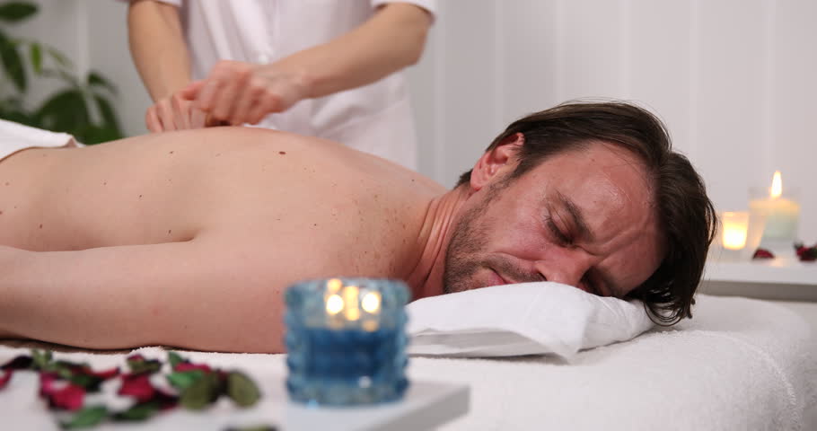 Spa Client Sophisticated Man Lying On His Front Receiving A Back Body Massage Spa Client Sophisticated Man Lying On His Front Receiving A Back Body Massage