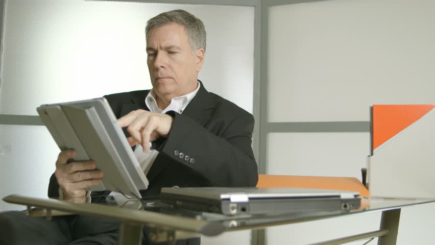 Businessman Dancing Excitedly At His Desk In Office Stock A Handsome Businessman In His Office Working With An Electronic Tablet Pc Closed