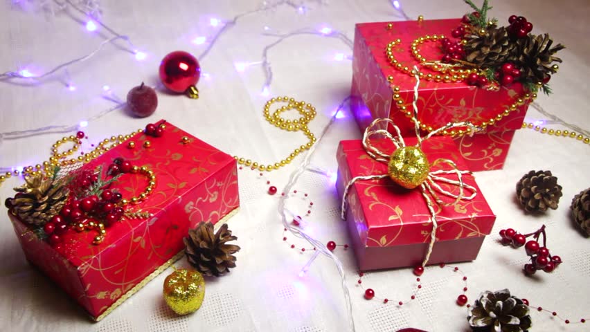 Red Handmade Gift Boxes And Christmas Decorations Golden Apples Bumps With Shimmering Lanterns Red Handmade Gift Boxes And Christmas Decorations Golden Apples Bumps With Shimmering Lanterns