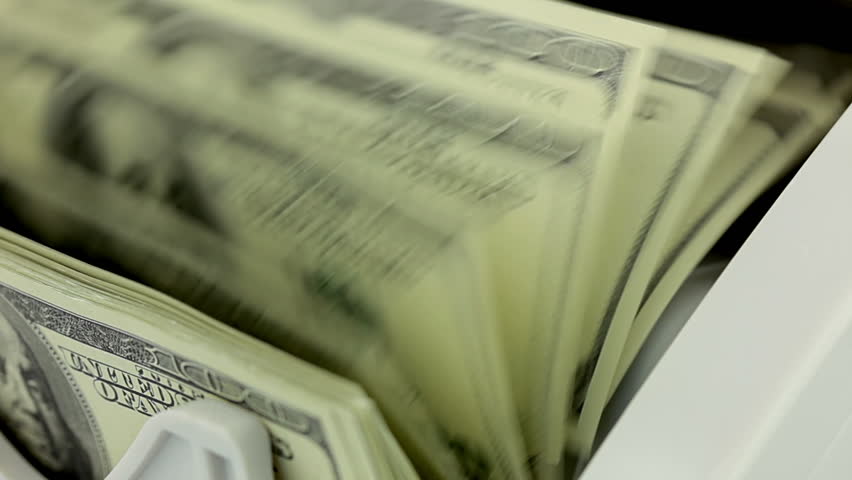 Cash money counting machine. Banknote counter are counting hundred dollar bills.