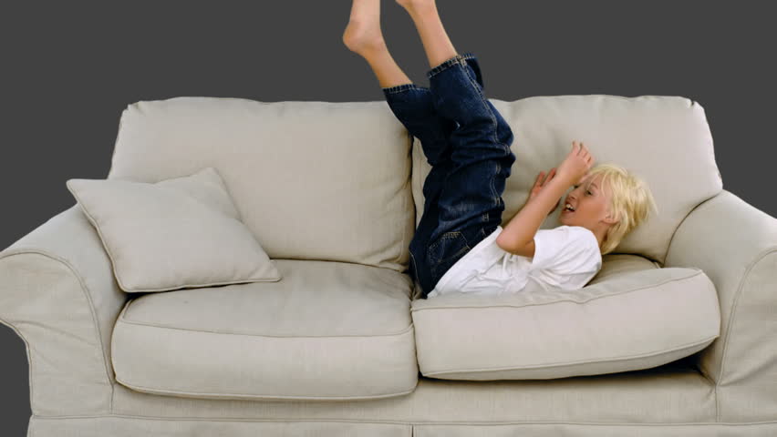 Little Girl With Broken Leg In Plaster Cast Lying On Sofa 