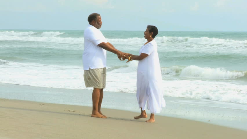 Barefoot Elderly African American Couple Holding Hands Walking On - 852x480 - jpeg Elderly Holding Hands Walking