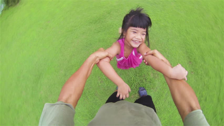 Little Asian Girl Playing In The Grass Running Into Man S